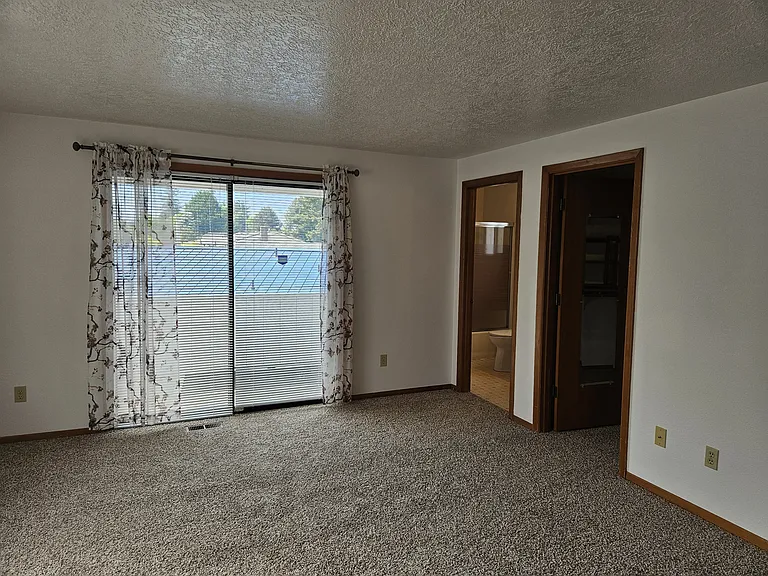master bedroom upstairs with sliding door to patio on suite bathroom & 2 walk in closets