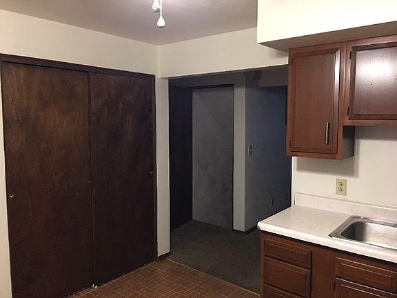 kitchen closet (on left); basement stairs (center); entry to living room (right)