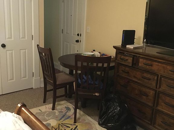 Living room facing closet and entrance