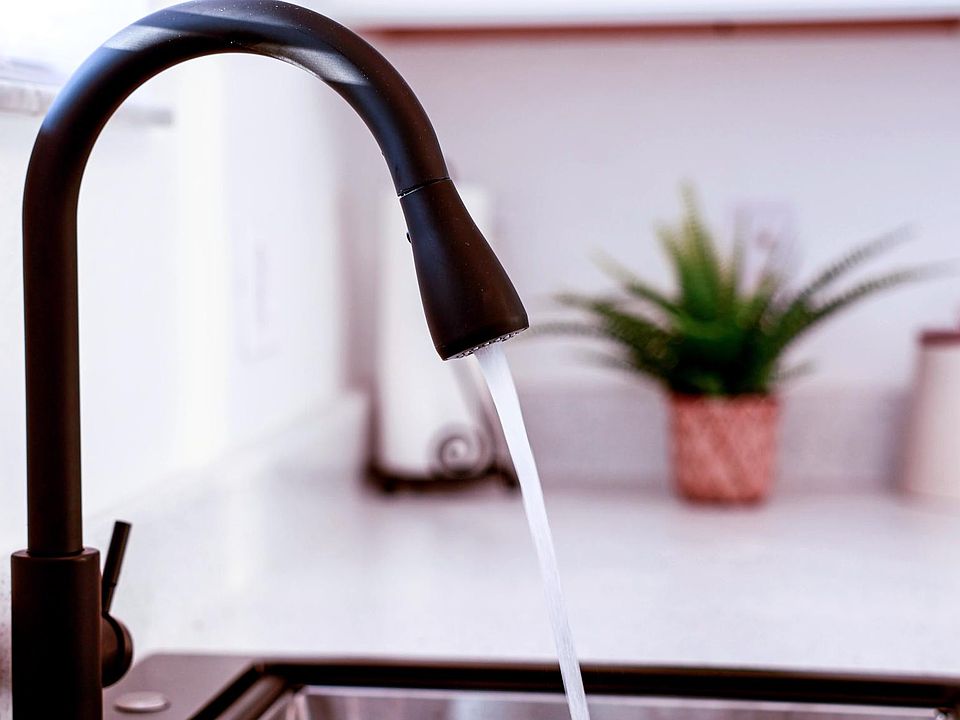 Kitchen sink with modern Kohl faucet and sink with disposal.