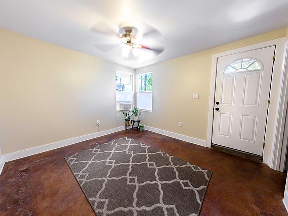 Living room, windows face the backyard. Window shades are bottom up so you can have privacy but still see out.