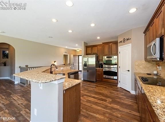 Kitchen includes 42" cabinets, double ovens, granite countertops, and a large pantry.