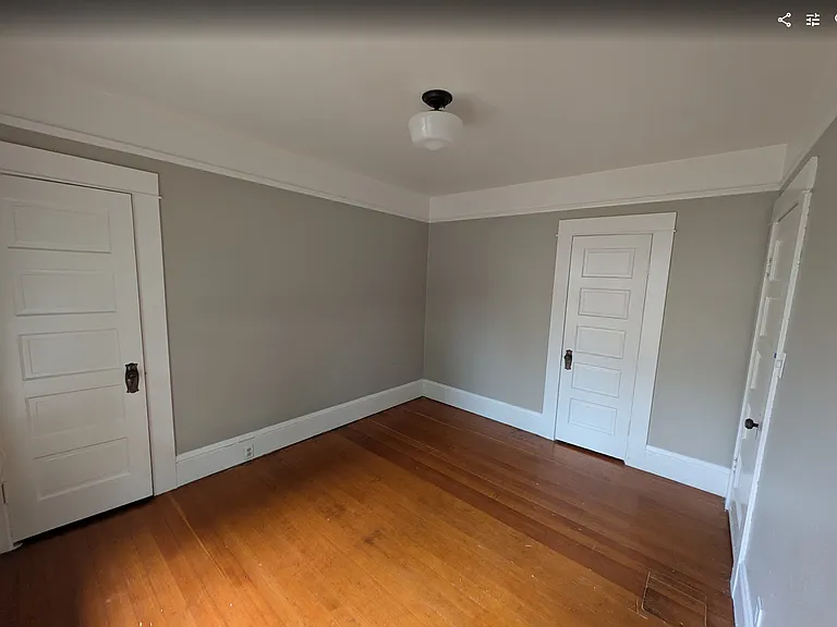 Bedroom #2, with doors to two small closets