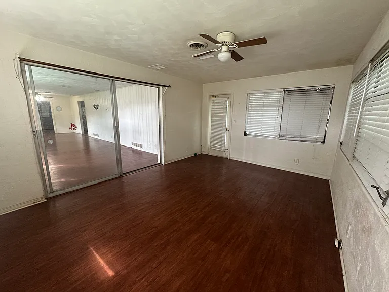 Another view of the bonus room and glass doors open to the main living room