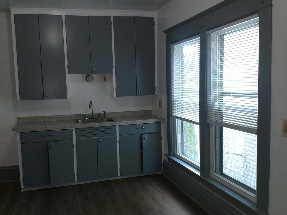 Kitchen with new flooring and countertops. Cabinets are repainted.