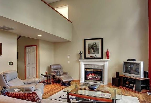 Staged living area with gas fireplace. Upstairs hall overlo