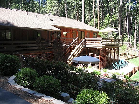 Back of home overlooks luscious gardens and stream