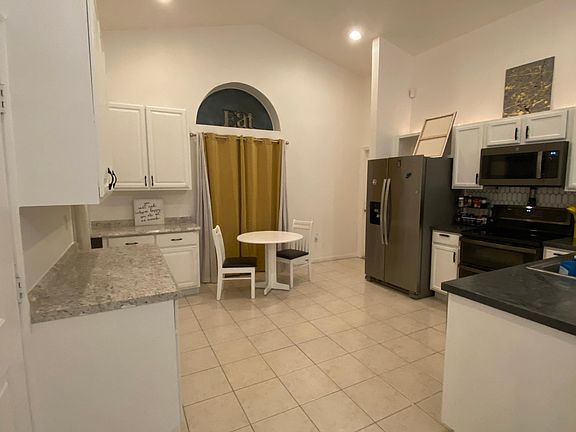 Open kitchen with plenty of storage! All new appliances (replaced 2023) including fridge, freezer, double oven, microwave/air fryer combo, and dishwasher