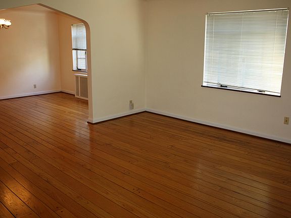 As you step into the apartment, the first thing you'll notice is the random width, pegged hardwood floors. You step into the living room which flows into the dining room.