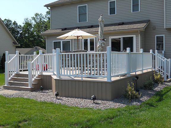 Huge maintenance free AZEK deck with beautiful stone & landscape lighting