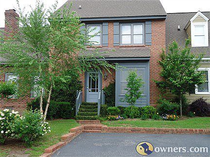 Brick townhome-steel gray trim with off street assigned parking