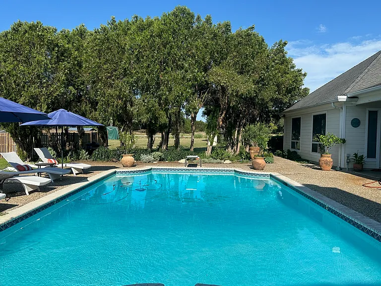 Pool. The apartment is accessed off of the covered pool patio.