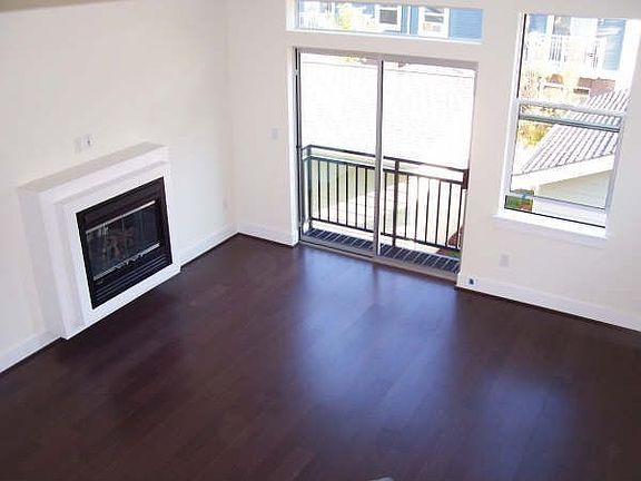 Light and Bright living room with sleek hardwood flooring and radiant heat!