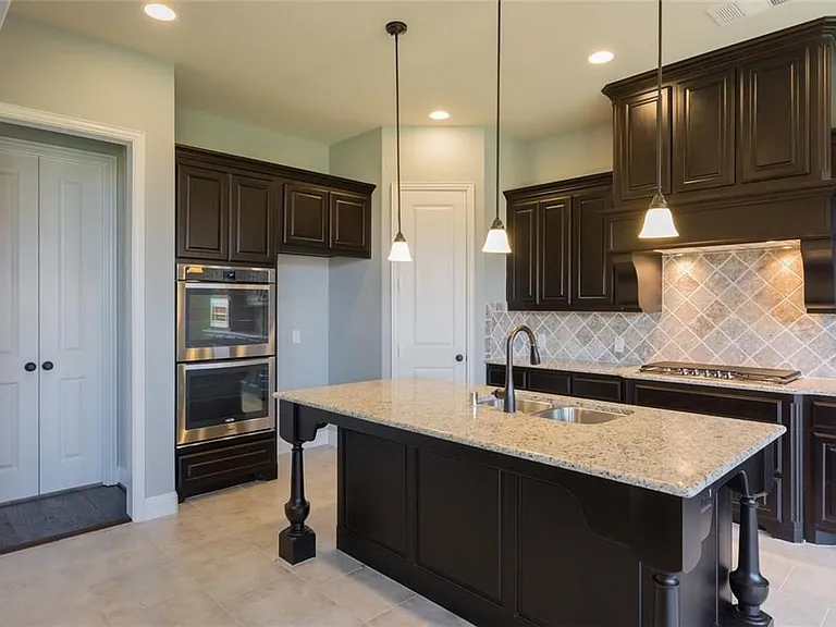 Pendant lights and granite counter top. Door leads into formal dining