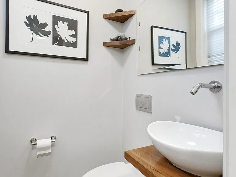 Powder room on the main level down the hall from the front entry.