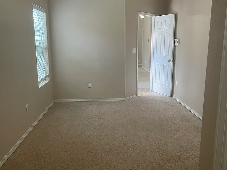 Master bedroom view from closets. Bedroom door leads into living room.