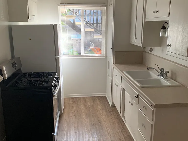 Galley kitchen with window allowing for plenty of light.