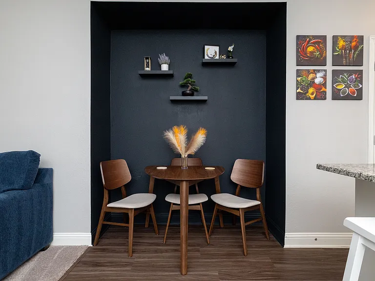 Cozy dining area nestled between the kitchen and living room, featuring a round table with seating for three _perfect for intimate meals or casual chats.
