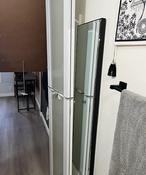 Full size mirror with hooks above.