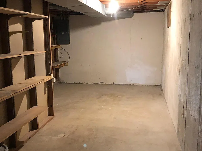Unfinished Basement Storage Area with Shelving