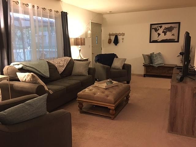 Upstairs living room with door to deck/gazebo and backyard