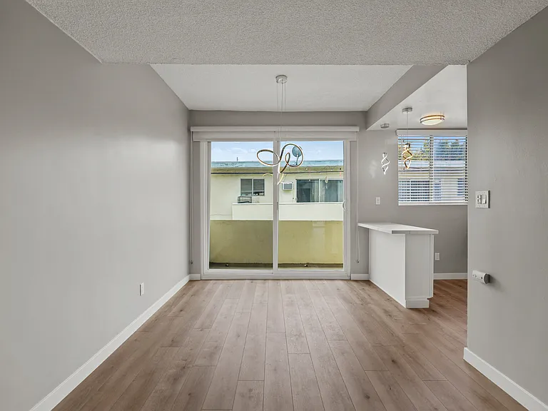 Open-Concept Kitchen, Dining, and Living Room Areas with Patio