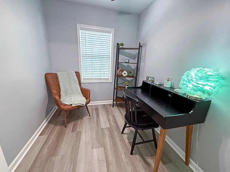 Home office with cozy leather chair for reading nook and book case ready for remote workers! (6'10" x 8'7")