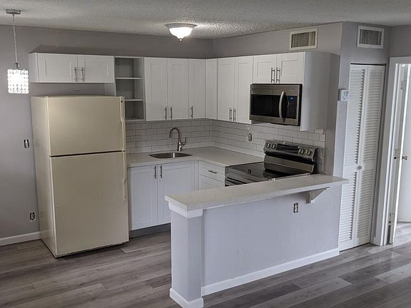 The matching stainless steel refrigerator will arrive in 3 weeks. Electric outlets are being upgraded. The missing cabinet door will be also installed this week