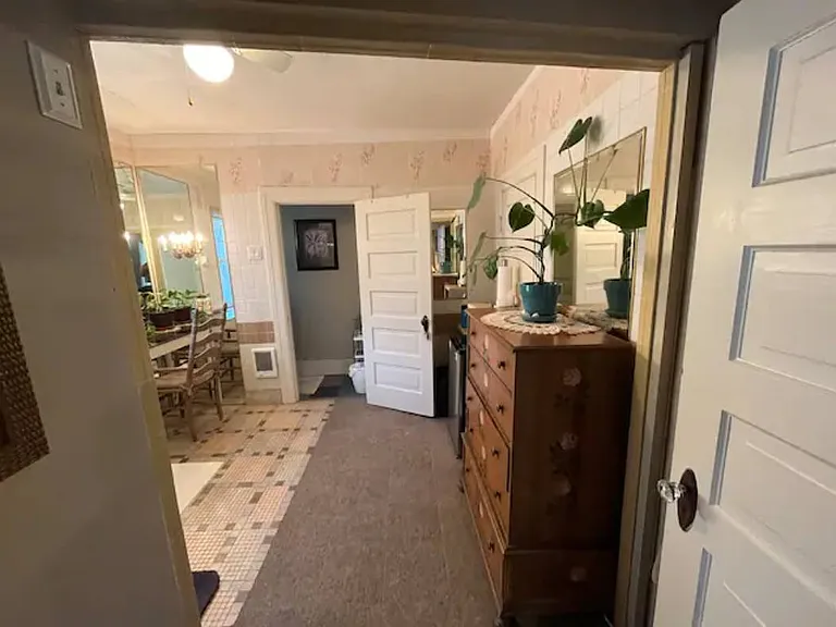 Private, en suite bathroom looking from Reading Nook doorway. Mirrored vanity is at far left. Toilet is thru door straight ahead.