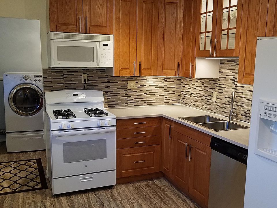 Quartz counter-tops, oak cabinets, tile backsplash, stove, disposal, dishwaser, microwave, refrgerator, washer and dryer included