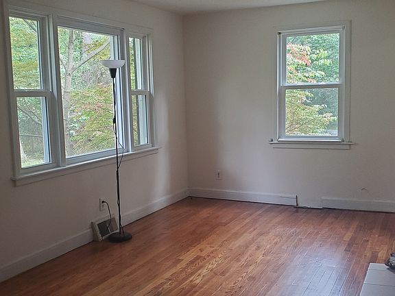 Living room showing front bay window. Windows pull out for easy cleaning and have screens and security locks and stops.