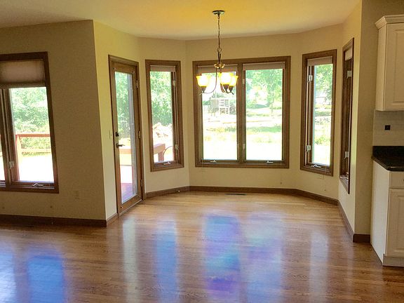 What a fabulous eating area tucked off the kitchen with lovely windows overlooking the backyard and deck