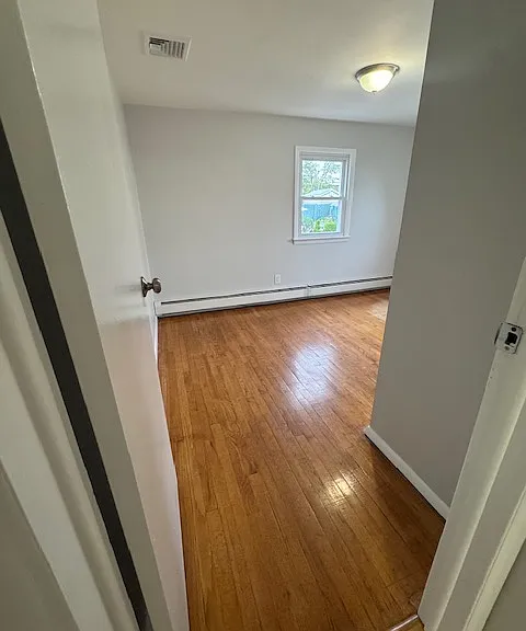 Bedroom 2: features natural lighting, hardwood floors and closet
