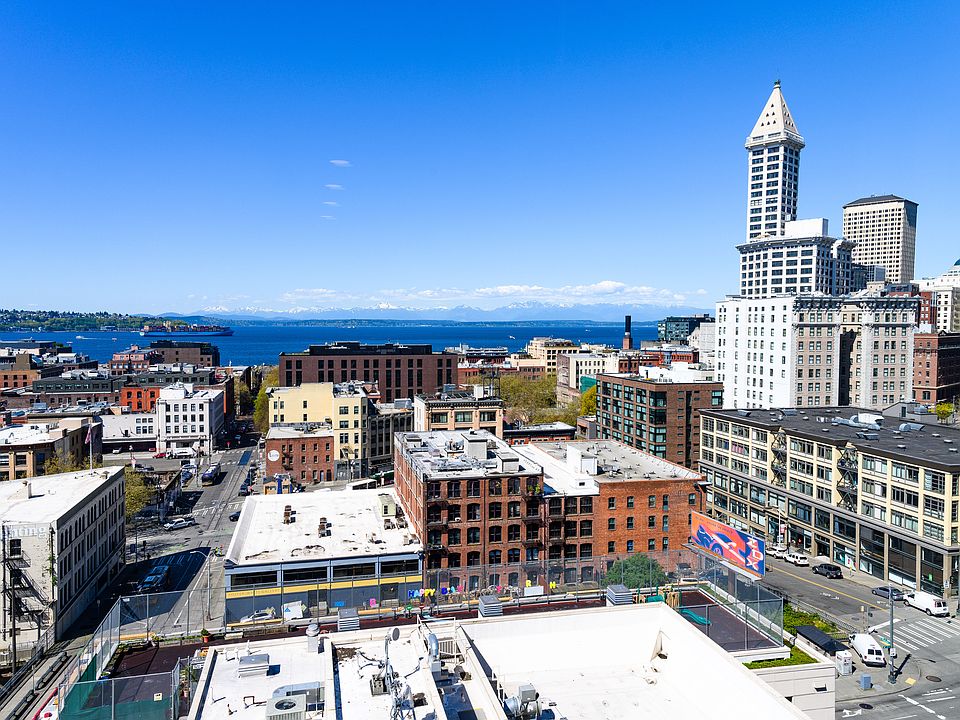 Beautiful water and city view from unit living room on a sunny Seattle day