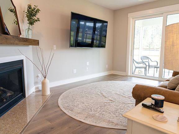 Living room with gas fireplace and extended glass doors