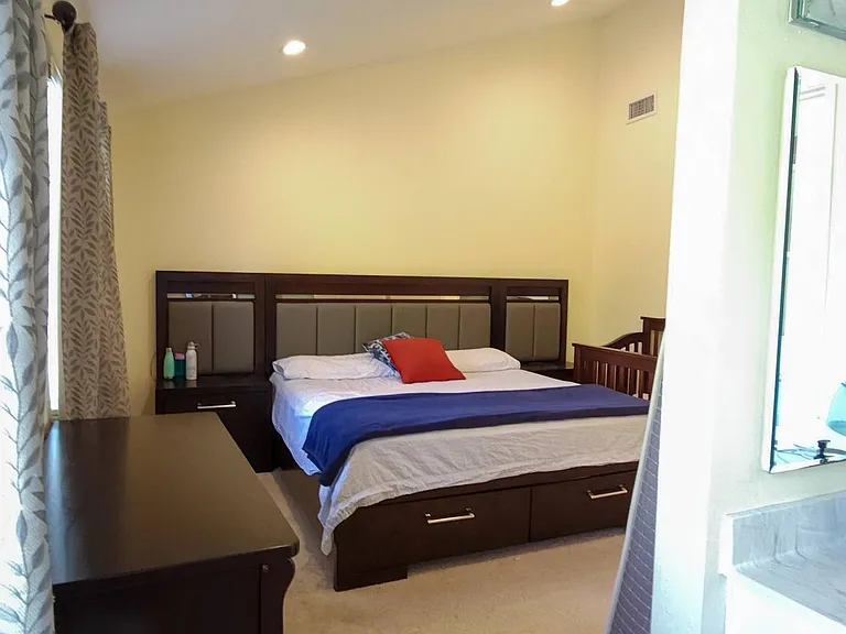 Master bedroom with carpets before which have now been replaced with wooden flooring