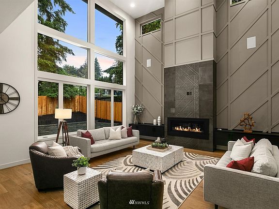 19' tall great room with tons of natural light, oversized designer fireplace, built in cabinets and a millwork accent wall.