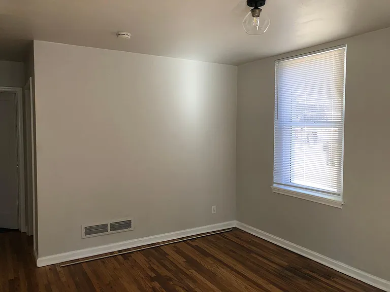 Refinished hardwood throughout living room.