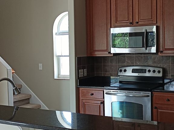 Kitchen with granite countertops open to the living and dinning room