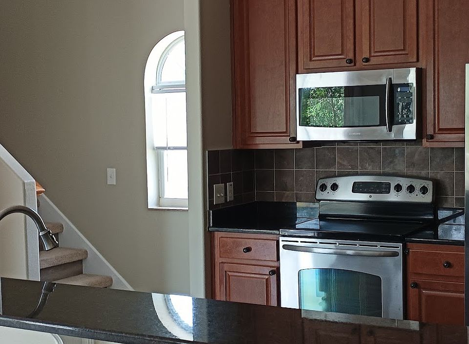Kitchen with granite countertops open to the living and dinning room