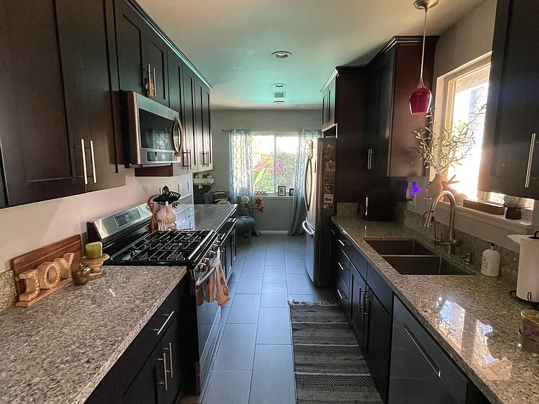 Kitchen, beautiful dark cabinets to ceiling with plenty of storage. Not pictured a pantry with double cabinets and pull out shelves for accessibility