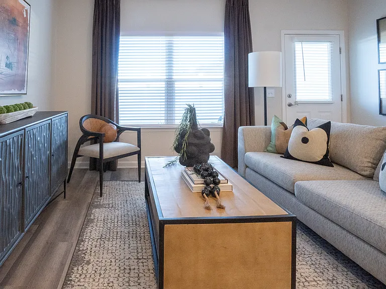 Living room with large window and back patio door access.