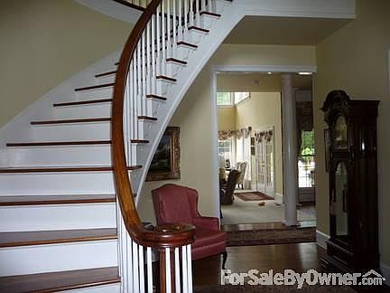 Foyer with circular staircase
						:
						Lovely custom built circular staircase. Cased opening leads to den 