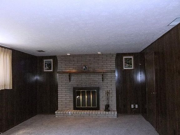 Family room with raised hearth gas fireplace.