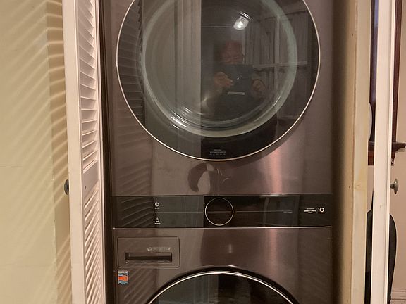 Washer and dryer located in main hallway of apartment