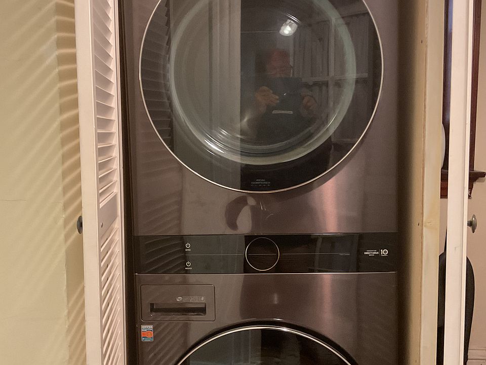 Washer and dryer located in main hallway of apartment
