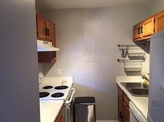 Galley kitchen has disposal and lots of cabinets