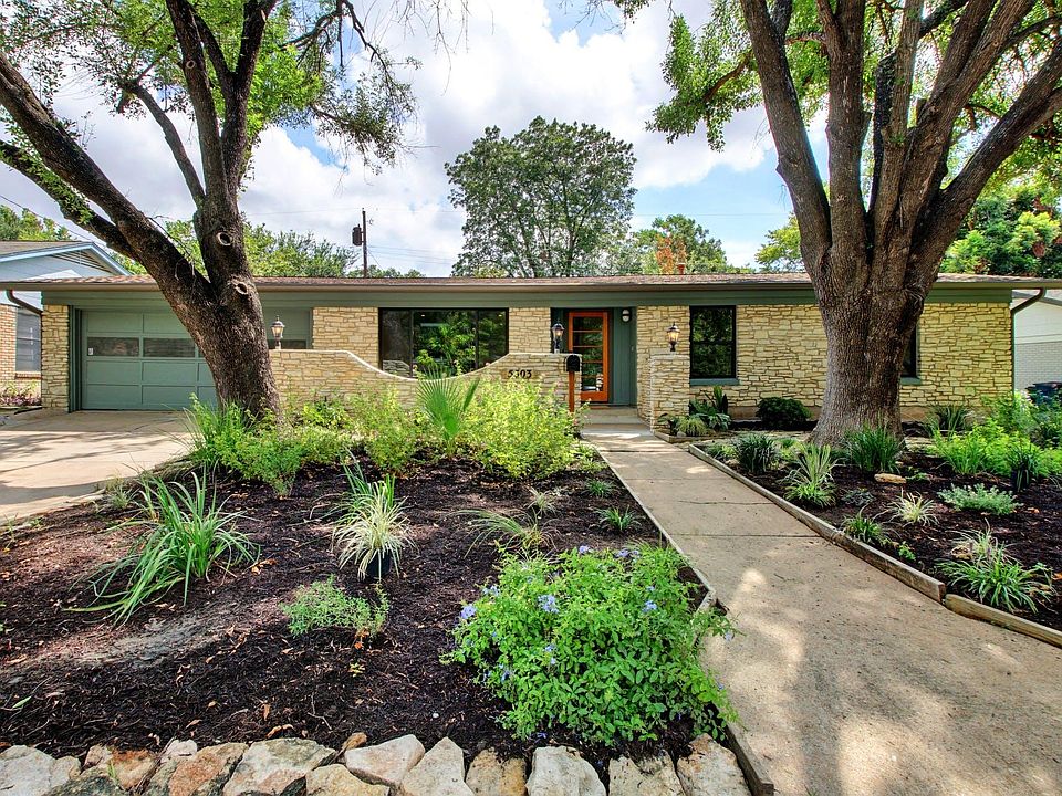 Shaded front yard with new landscaping with irrigation system. 2 car garage
