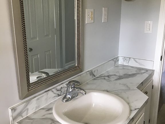 Master bathroom with tub/shower and a water-saving toilet