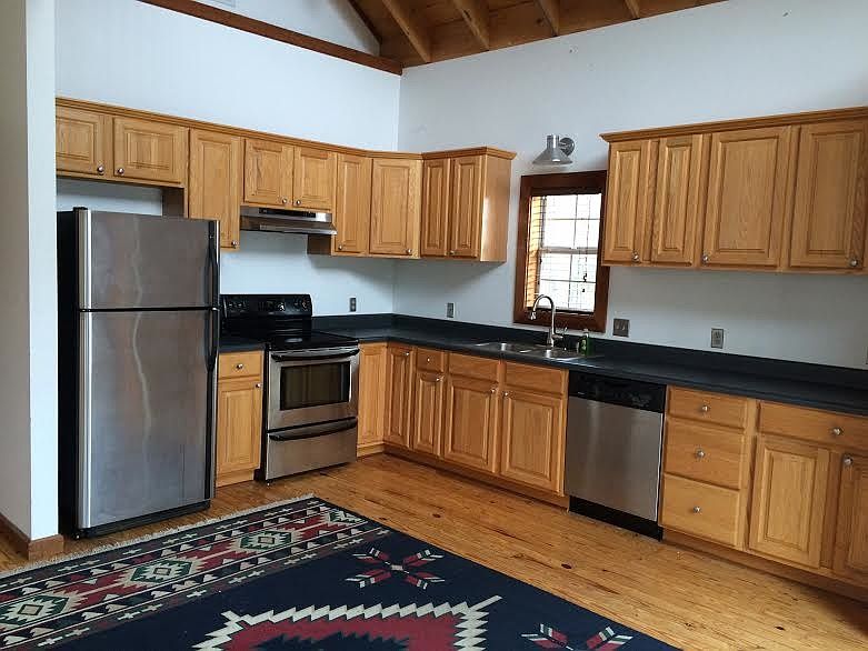 kitchen with dining area, has pantry and vaulted ceiling
